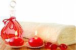 red spa decoration with massage oil bottle and candles