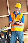 Confident male worker holding a clipboard at work