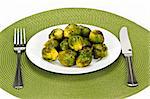 Plate of green brussels sprouts with knife and fork