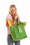 Young woman with groceries in recycle bag