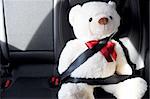 fasten your seat belt concept with teddy bear showing car safety