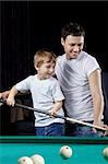 The young man with the son plays billiards
