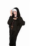 Young, attractive Catholic nun dancing on a white background