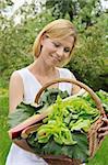 Young woman holding basket with vegetable