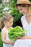 Young mother and daughter with lettuce