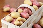 Red and white organic potatoes in a basket. Shallow dof