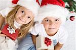 Kids with their christmas presents presents sitting on the floor