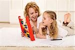 Little girl doing math exercises with her mother at home