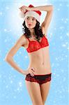 young beautiful girl wearing sexy lingerie and a christmas hat posing over white background