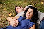 A couple taking a refreshing break outdoors in a park - sharp focus on female