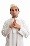 Man wearing kurta robe and topi cultural clothing - thinking and looking up.   White background.