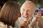 Senior couple at home with a telephone