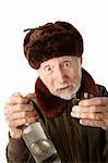 Senior Russian Man in Fur Cap and Jacket with Vodka