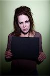 woman with messy hair takes mugshot