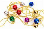 Colorful Christmas baubles on a gold string on white background with copy space.