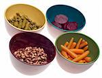 Variety of Canned Vegetables in Bowls including Carrots, Beets, Asparagus and Black Eyed Peas.  Isolated on White.