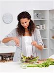 Cute hispanic woman preparing her lunch in the kitchen at home