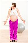 Dissatisfied with her weight pregnant woman standing on weight scale at home