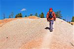 A female hiker climbs a hill in Bryce Canyon, Utah