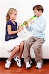 Cute kids playing flute together