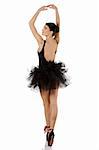 beautiful girl classic dancer with black dress and shoes on white background dancing in point