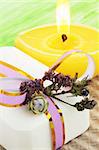 Soap,  candle  and dry flowers against the light-green background