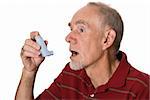Old man using asthma inhaler to control allergies. Isolated on white.