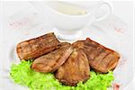 Beef tongue closeup with sauce isolated on a white background