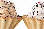 Macro view of two cakes with whipped cream isolated over white