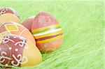 Painted brown Easter Eggs on green Grass