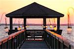 A cozy bungalow on a pier at sunset