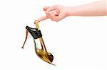 Hand holding woman shoe isolated on white