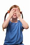 Little girl with eyes closed by her hands isolated over white background