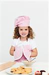Cute girl with kitchen gloves while preparing cookies in the kitchen
