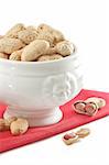 Peanut in a white ceramic bowl on a red linen napkin