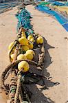 Trawl fishing nets and tackle drying on a pier