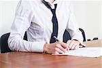 Young business woman writing document in office