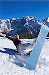 Happy female snowboarder havin fun in mountains