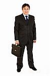 Full length portrait of smiling businessman holding  briefcase in hand isolated on white