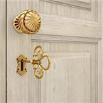 golden door handle and a golden key. 3d image.