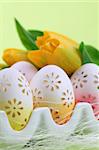 Flowery Easter eggs in an egg holder. Shallow dof