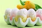 Flowery Easter eggs in an egg holder. Shallow dof