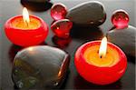 zen harmony with candles and stones on black background