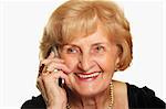 A portrait of a happy senior lady talking on the phone against white background