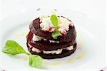 appetizer salad of beets and goat cheese with basil and olive oil