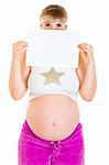 Pregnant woman holding empty white  paper in front of her face isolated on white.