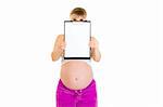 Pregnant woman holding blank clipboard in front of her face isolated on white
