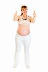 Smiling pregnant woman showing  thumbs up gesture isolated on white