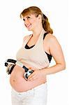 Happy pregnant woman holding headphones on her belly isolated on white