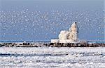 The Cleveland Harbor West Pierhead Lighthouse covered in ice. The lighthouse, built in 1911, guides ships from Lake Erie into the Port of Cleveland and the Cuyahoga River.